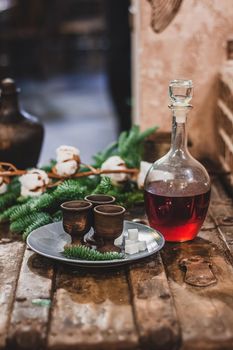 Christmas vintage background, craft alcohol drink and ancient dishes, fluffy fir branches and festive decor