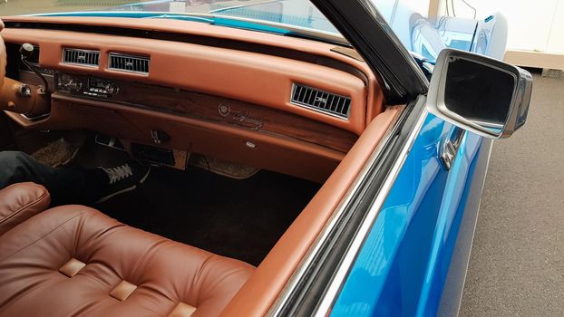 Ukraine, Kiev - March 27, 2020: vintage retro classic car Cadillac beatriz of blue color. emblem on the hood with a logo. original parts of the restored American car. photos from different angles