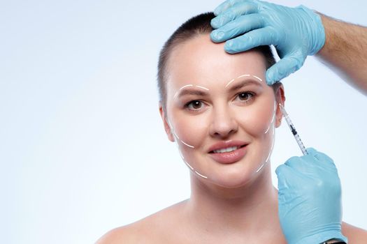 Portrait of attractive woman with arrows on her face skin for cosmetology