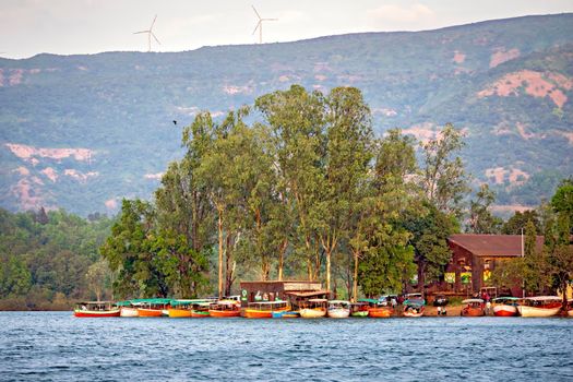 Colorful small boats berthed on the banks of backwater of Koyana river in Bamnoli.