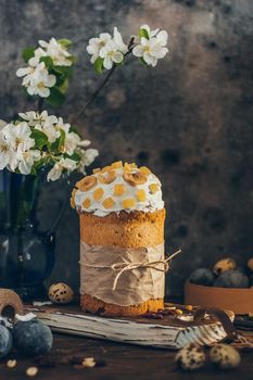 Traditional Russian Orthodox Easter bread - kulich with apple blossom and colored eggs