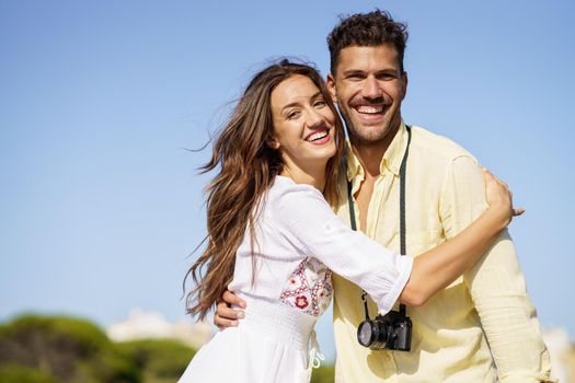 Happy smiling couple hugging each other outdoors