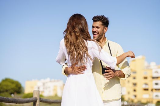 Happy smiling couple hugging each other outdoors