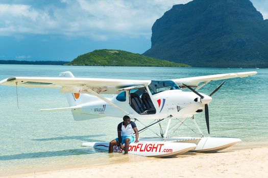 Born to Fly , MAURITIUS-December 9, 2019: Beautiful tropical summer landscape with seaplane for guided tours along the Indian Ocean coast, Mauritius, December 9, 2019.