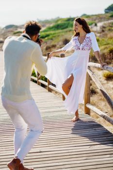 Man photographing his girlfriend on a lovers' trip Couple enjoying a natural environment.