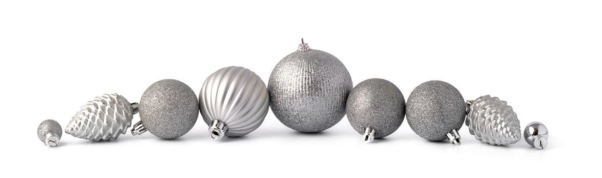 Pile of Christmas baubles isolated on white background, close up