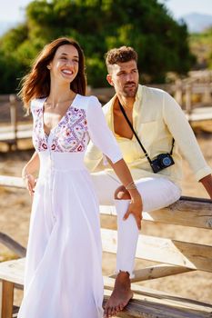 Happy loving couple looking at the horizon in a natural area