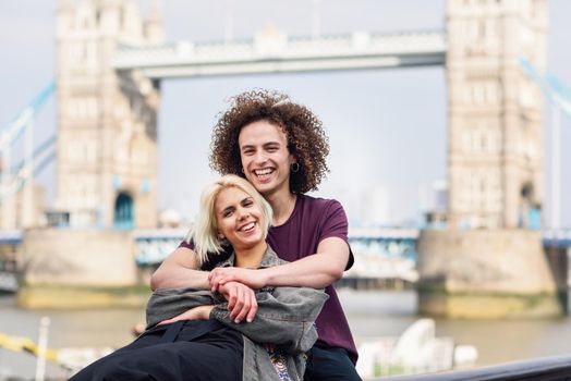 Happy couple hugging at the Tower Bridge, River Thames, London. UK