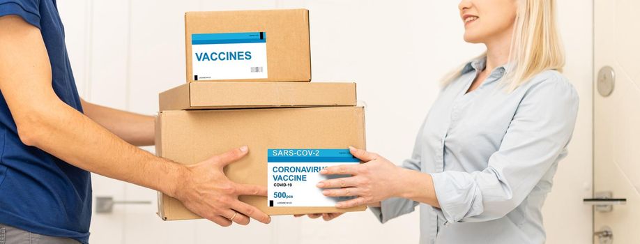 medical worker accepting delivery of covid-19 vaccines from deliveryman.