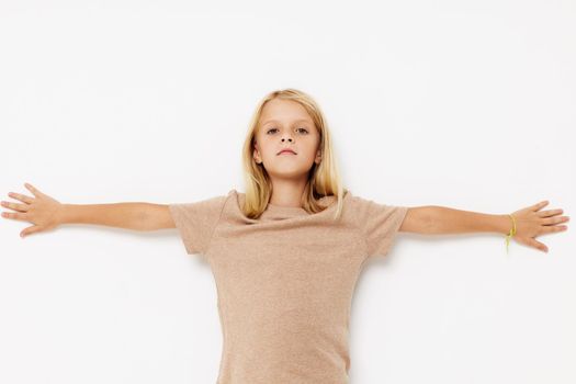 Little cute girl with blond hair posing studio. High quality photo