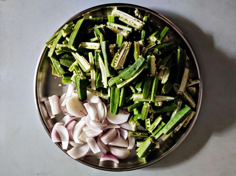 Freshly pre-cut vegetables arranged in a plate for dinning preparations in home.