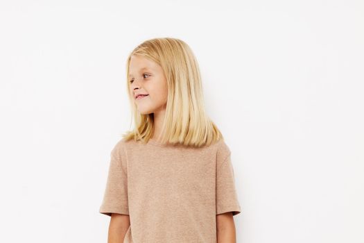 Portrait of a smiling little cutie in a beige t-shirt lifestyle concept. High quality photo