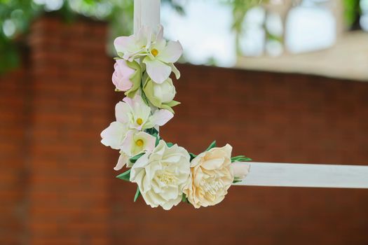 Decorating events, close-ups of decor details. Wooden white frames decorated with flowers in the outdoor garden