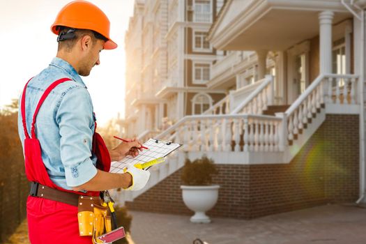 Smiling Construction worker man. Architecture background.