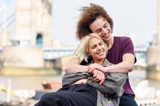 Happy couple hugging at the Tower Bridge, River Thames, London. UK