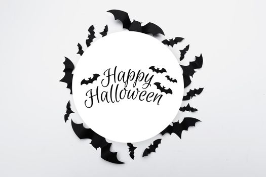 Halloween concept - black paper bats on white background