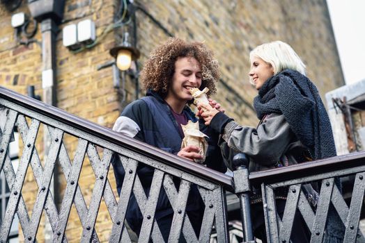 Happy couple eating Doner kebab, shawarma, in Camden Town, London. UK