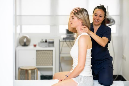 Female Physiotherapist inspecting her patient. Medical check in a physiotherapy center.