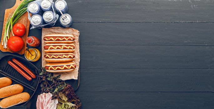 Barbecue Grilled Hot Dogs with  yellow American mustard, On a dark wooden background