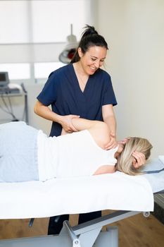 Female Physiotherapist inspecting her patient. Medical check in a physiotherapy center.