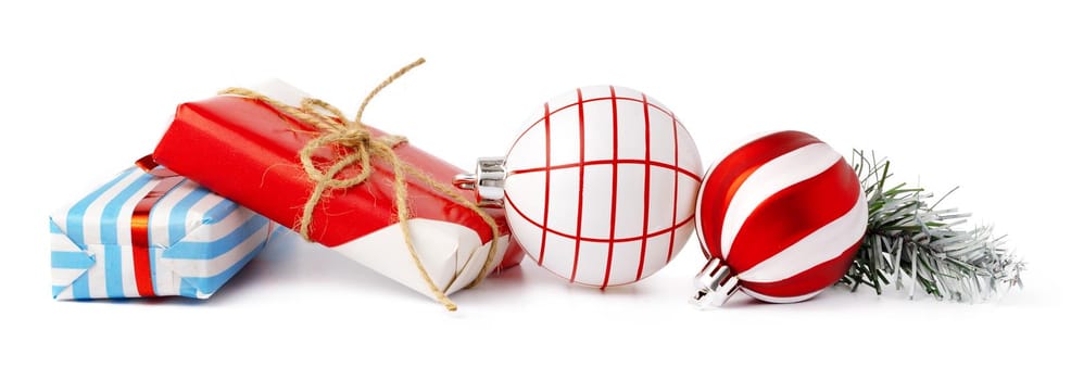 Christmas baubles and festive gift box isolated on white background, close up