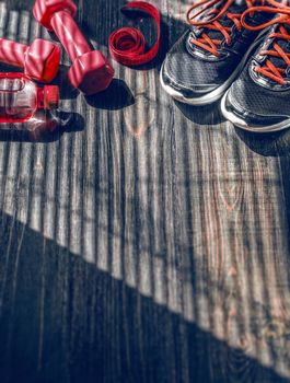 Sneakers dumbbells and a bottle of water. Flat view. All in one color.