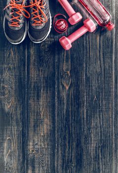 Sneakers dumbbells and a bottle of water. Flat view. All in one color.