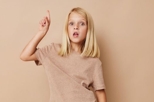 Little cute girl gestures with his hands lifestyle concept. High quality photo
