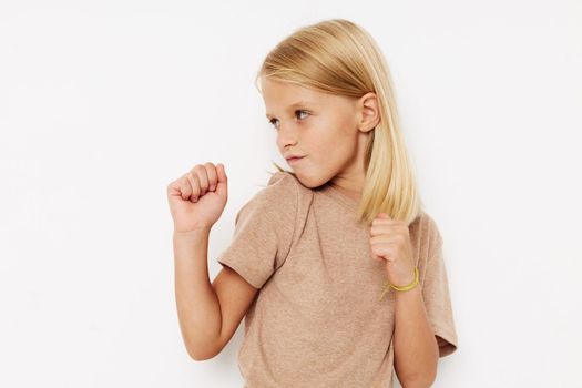 emotional girl with blond hair on a light background. High quality photo