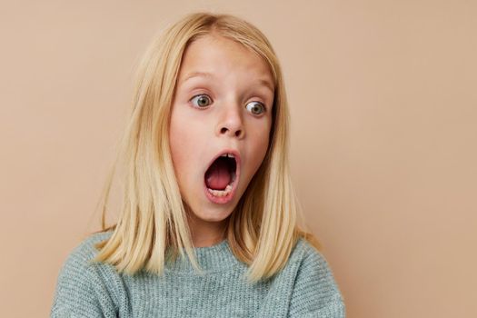 happy child with blond hair posing studio. High quality photo