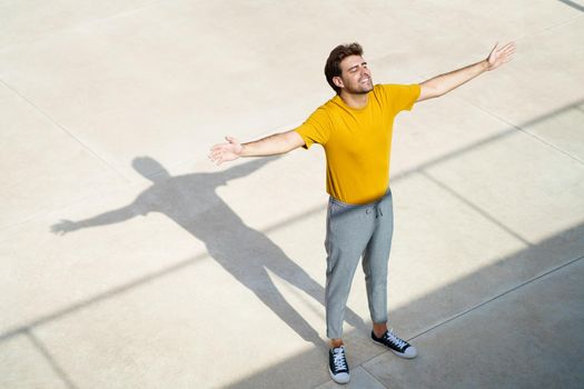 Top view of a young man opening his arms