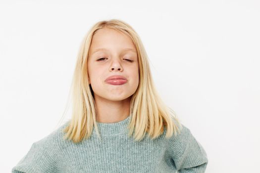 Beautiful little girl gestures with his hands cropped view. High quality photo