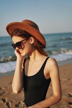 cheerful woman in sunglasses Sandy coast landscape sun. High quality photo