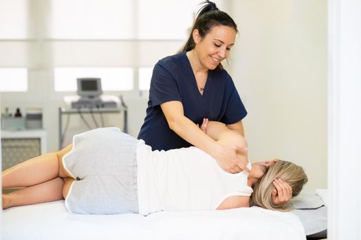 Female Physiotherapist inspecting her patient. Medical check in a physiotherapy center.