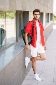 Young fashionable man standing outdoors wearing casual clothes