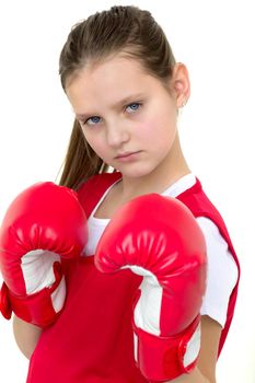 Sports boxer teenage girl. Close up portrait of beautiful girl in red sports uniform and boxing gloves doing boxing exercises. Teenager child posing in studio on white background