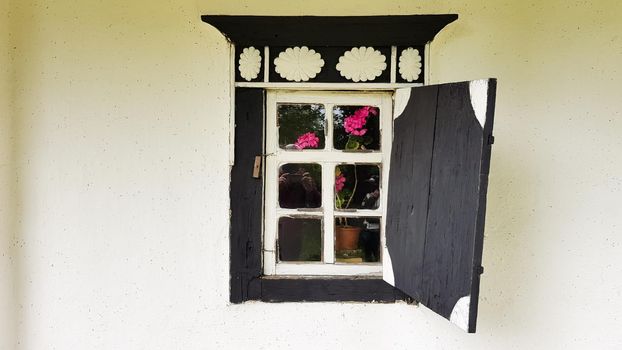 Ukraine, Kiev - June 11, 2020. Old window in a vintage traditional peasant house in Ukraine. Antique wooden window frame. Pirogovo National Museum in the open air in Kiev. Copy space