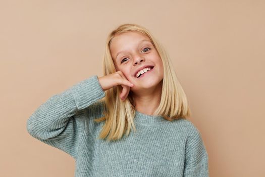 emotional girl in a sweater, grimaces posing studio. High quality photo