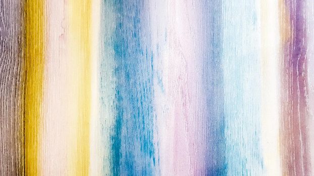 Textured wooden background painted in different colors of the rainbow. Colorful colored abstract background