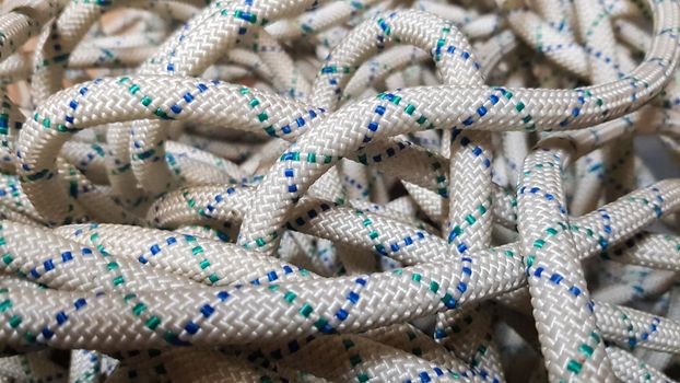 A background image of a tangled rope for rock climbing and mountaineering