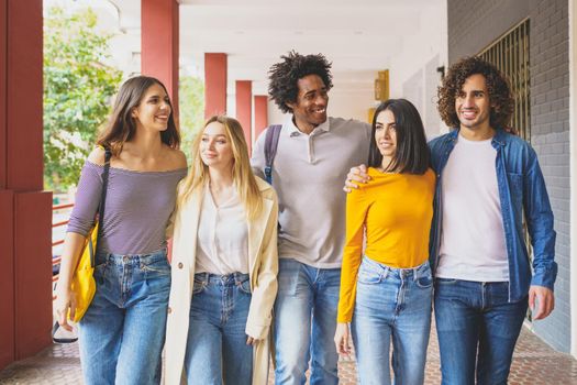 Multi-ethnic group of students walking together on the street while chatting and having fun.