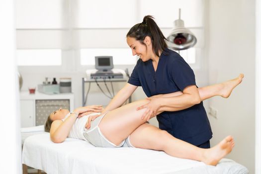 Female Physiotherapist inspecting her patient. Medical check in a physiotherapy center.