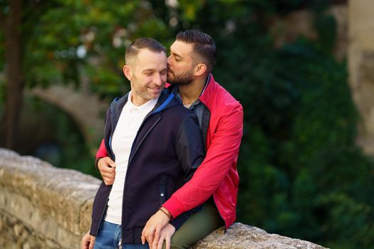 Gay couple in a romantic moment in a beautiful place near the river. LGTB relationship concept.