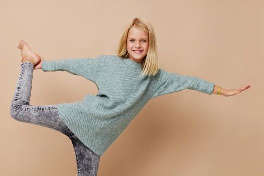 Little cute girl in a sweater, grimaces kids lifestyle concept. High quality photo