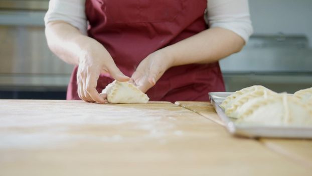 The process of making pies with hands close-up