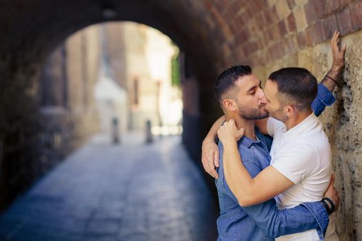 Gay couple kissing in a romantic moment. Homosexual relationship concept.