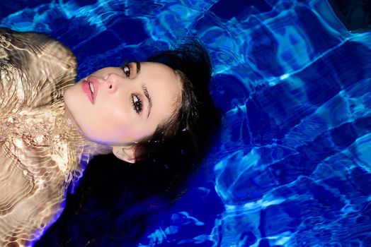 Young sexy attractive woman in pool, sensual look