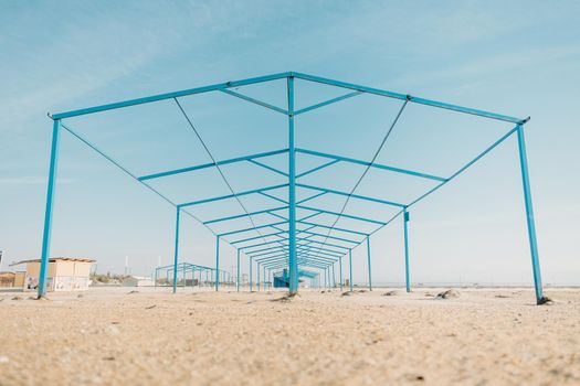 Minimalistic geometric metal construction on sand beach.
