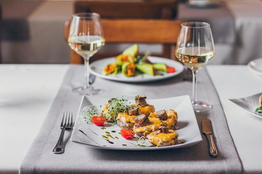 Stuffed mushrooms filled with cheese, mushroom stems, fresh cherry tomatoes and microgreen.