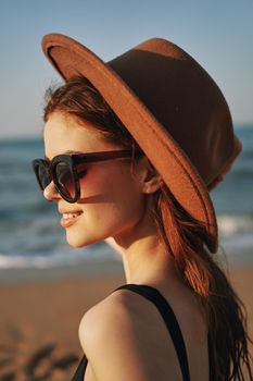 cheerful woman in sunglasses Sandy coast landscape sun. High quality photo